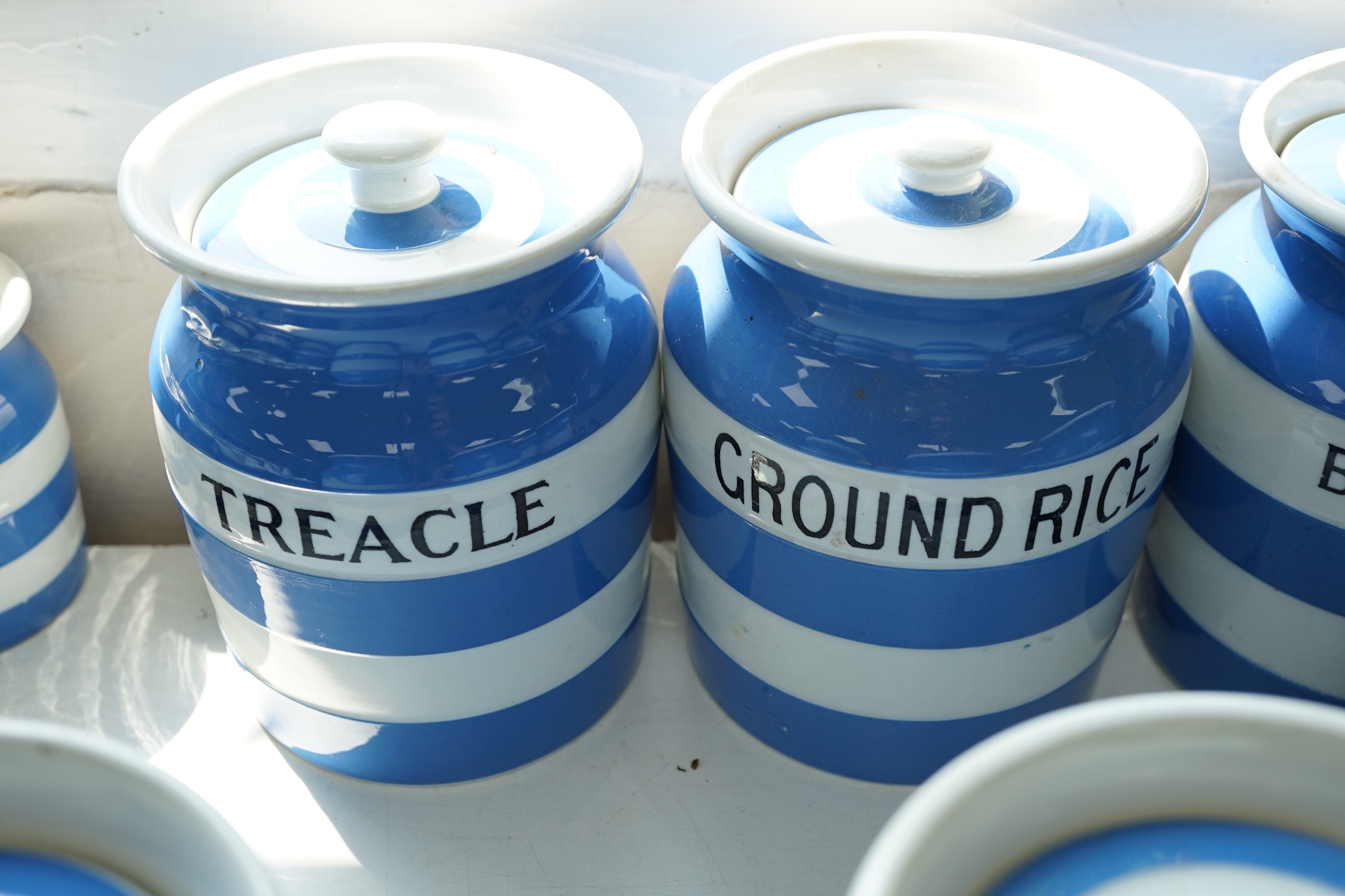 T.G.Green Cornish Kitchenware, seven 14cm lidded storage jars to include Vermicelli, Macaroni, Treacle, Biscuits and Prunes with a smaller Biscuit jar and cover, mainly Green Church marks. Condition - poor, fair and good